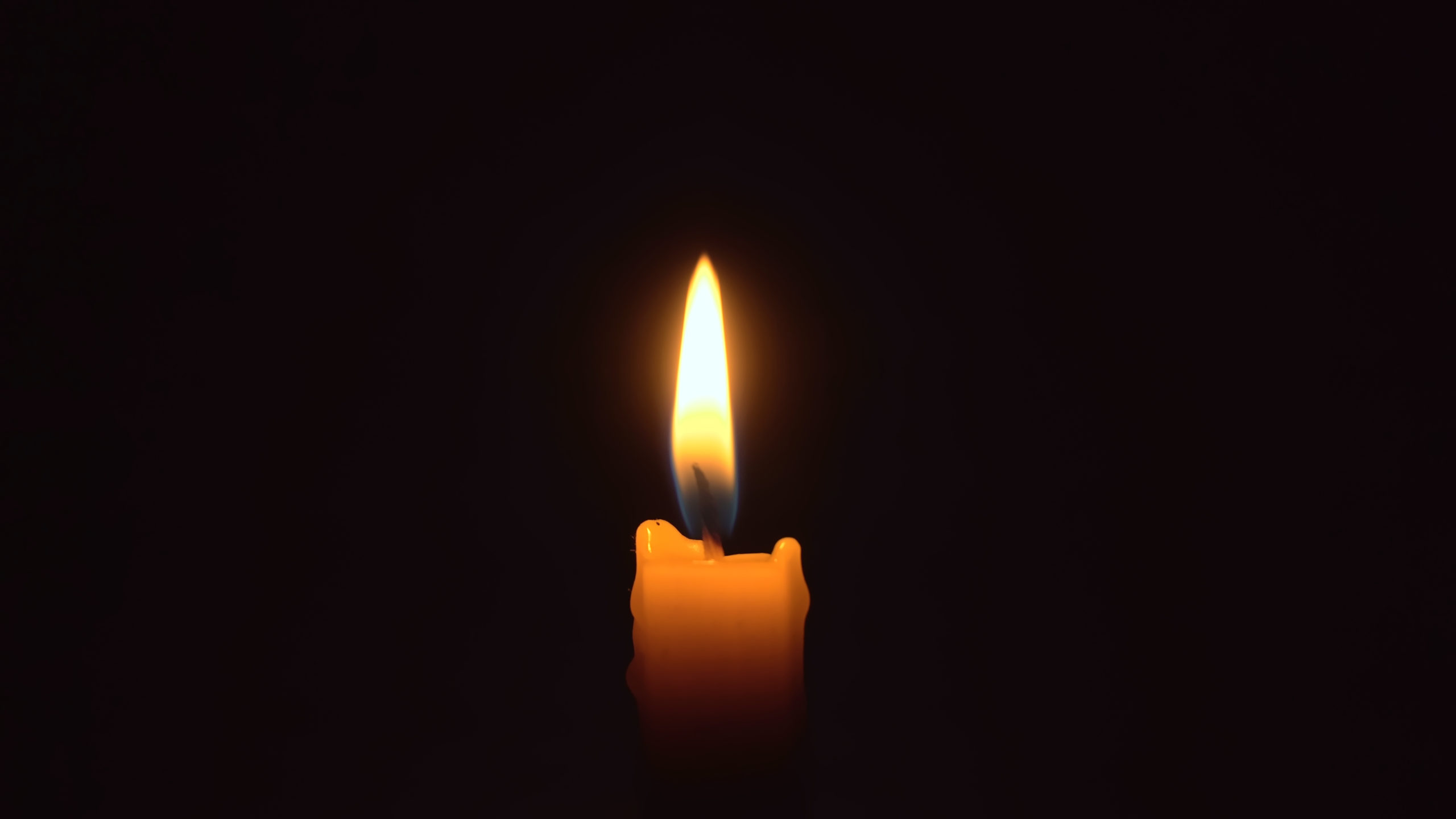 A single candle light in the darkness